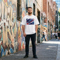 Australia Socceroos Light. Man standing on sidewalk with graffiti walls behind. 