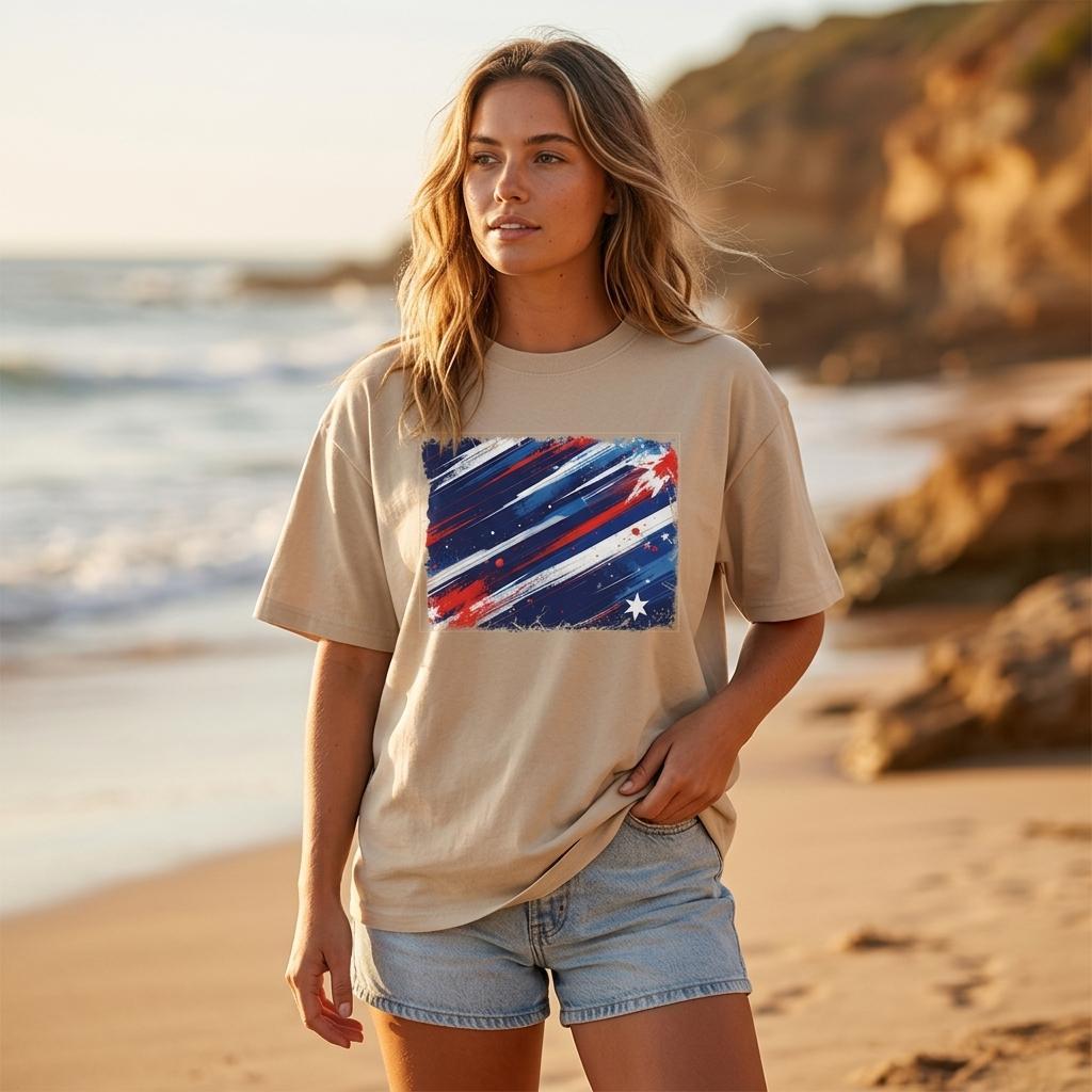 Australia Socceroos Sand. Woman wearing a beige t-shirt with a colorful graphic on a beach