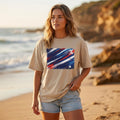 Australia Socceroos Sand. Woman wearing a beige t-shirt with a colorful graphic on a beach