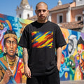 Ecuador La Tri Dark Mode. Person wearing a black t-shirt with a colorful design in front of a mural.