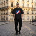 France Les Bleus Dark Mode. Man wearing a black t-shirt with a colorful graphic design in an urban setting