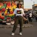 Ghana Black Stars Light. Person standing on a street with colorful graffiti in the background