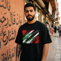 Iraq Lions of Mesopotamia Dark. Man wearing a black t-shirt with a flag design on a street background