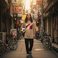 Japan Samurai Red Sand Mode. Person holding a soccer ball in a busy urban street with bicycles and signs.
