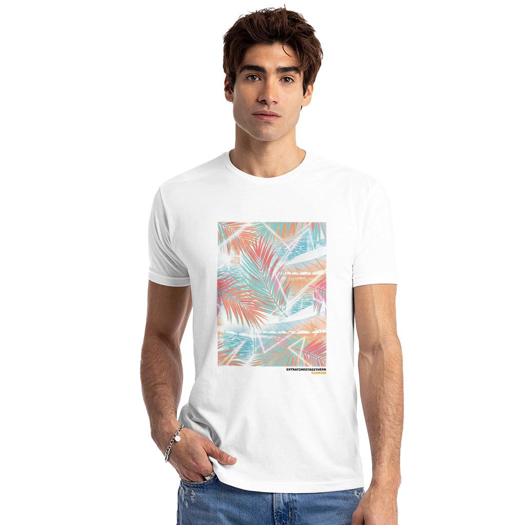 Man wearing white shirt with palm leaf inspired design on front. 