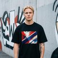 Norway Vikings Dark. Person wearing a black t-shirt with a colorful graphic design in front of a graffiti-covered wall.
