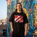 Turkey Crescent Stars Dark. Person wearing a black t-shirt with a red and white design in front of a colorful mural.