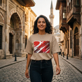 Turkey Crescent Stars Sand. Woman standing on a cobbled street with historic architecture in the background