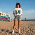 Uruguay La Celeste Light Mode. Woman standing on a beach with graffiti in the background