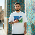 Uzbekistan White Wolves Light. Man holding a phone in front of a decorative wall with geometric patterns